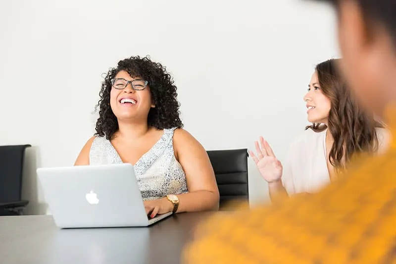 Image of lady laughing with laptop